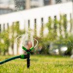 Green lawn automatic irrigation system in park. Watering lawn at heat summer.